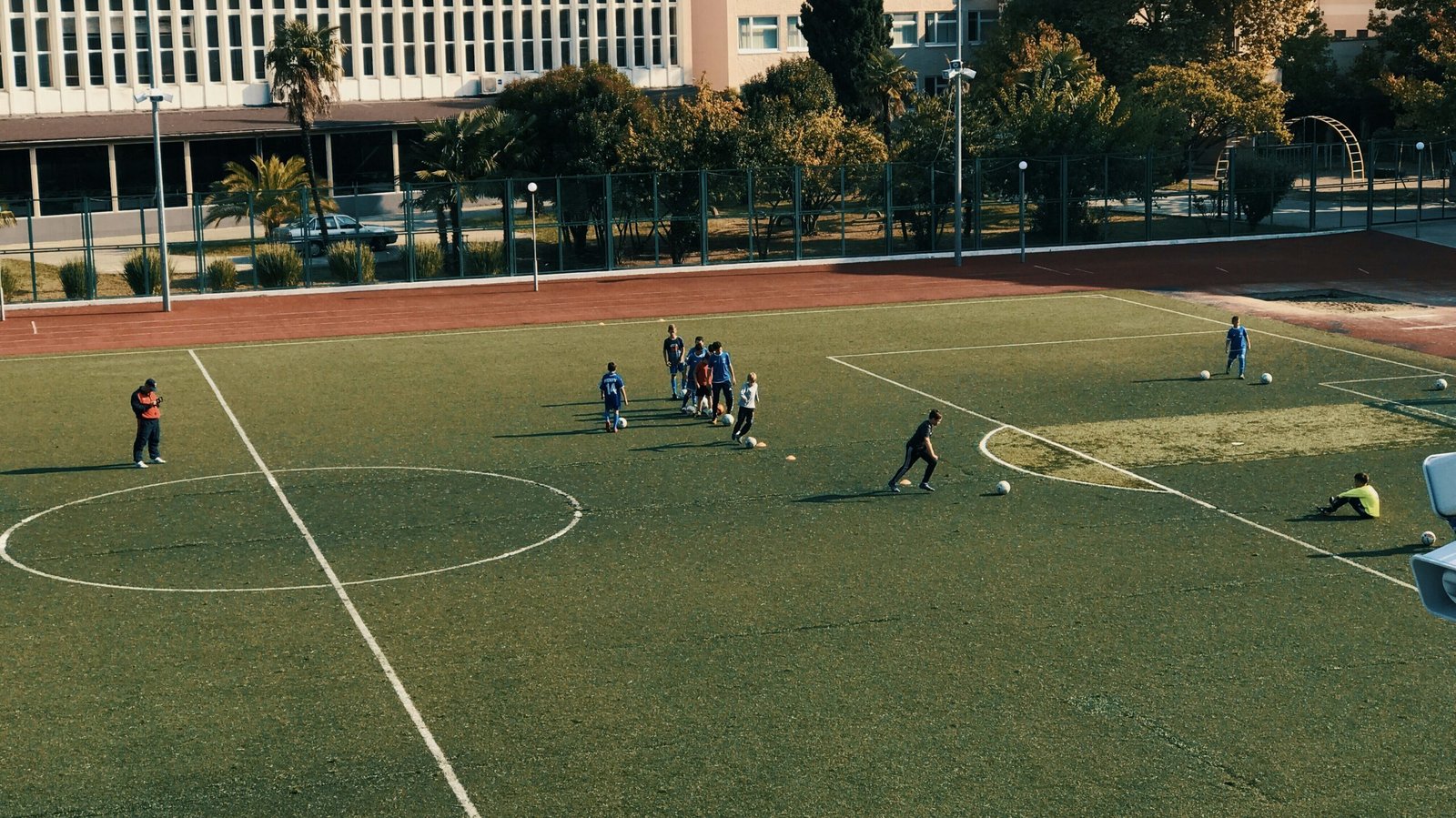 people playing soccer on open field